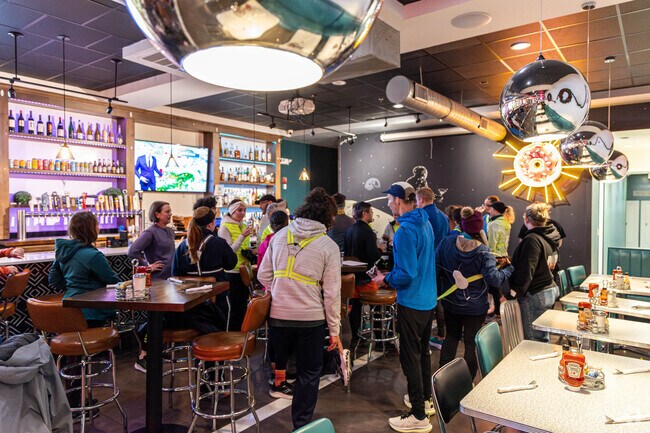 Residents of Arlington Center enjoy some food at Donut Villa after their run with Marathon Sports.