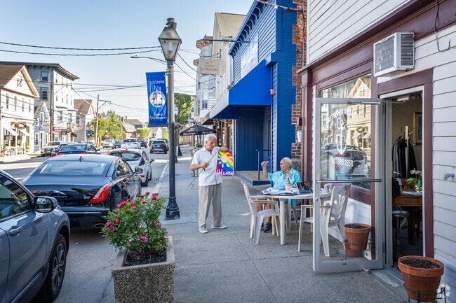 A couple of old friends are enjoying an outdoor meal on Main Street, Nichols Corner, RI.