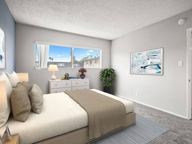 Carpeted bedroom with large window for natural light.