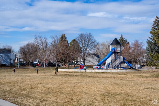 Families enjoy the playground and open green area at Quail Crossing Park.