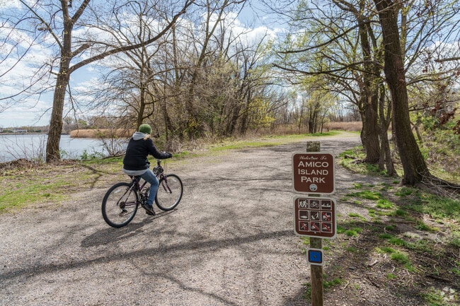 Cyclists enjoy the trails that run along the water at Amico Island Park.