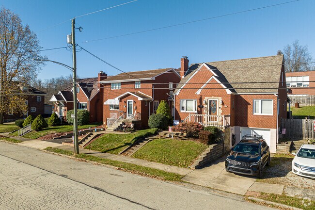 Two brick Cape Cods flank a brick two-story neighbor along this street in Youngwood.