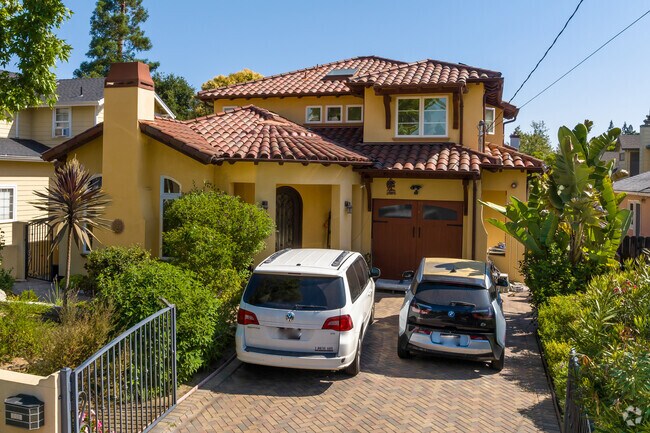This two story yellow and red home in Midtown has a banana tree in the front yard.