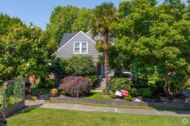 A home peeks out behind native and tropical trees on McGilvra Blvd E in Madison Park.