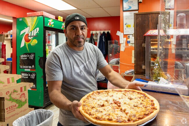 Order by the slice or full pizza at Millo's Pizzeria near East Calumet.