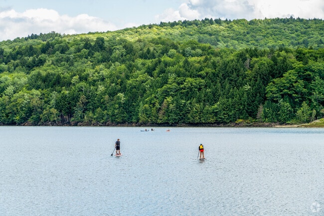 Paddleboarders glide on the Waterbury Reservoir near Bolton Valley.