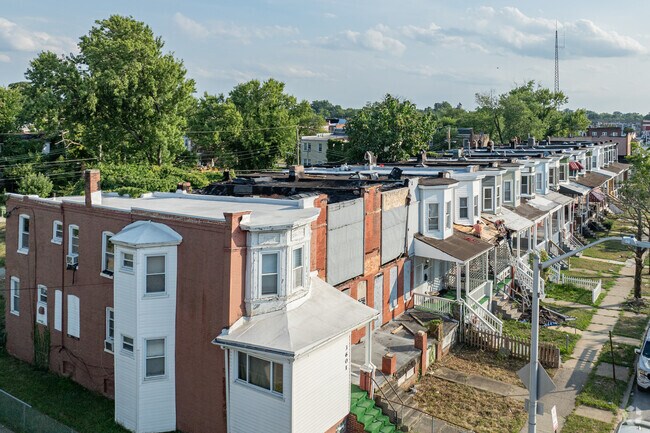 Traditional Baltimore brick row houses line the streets of Langston Hughes.