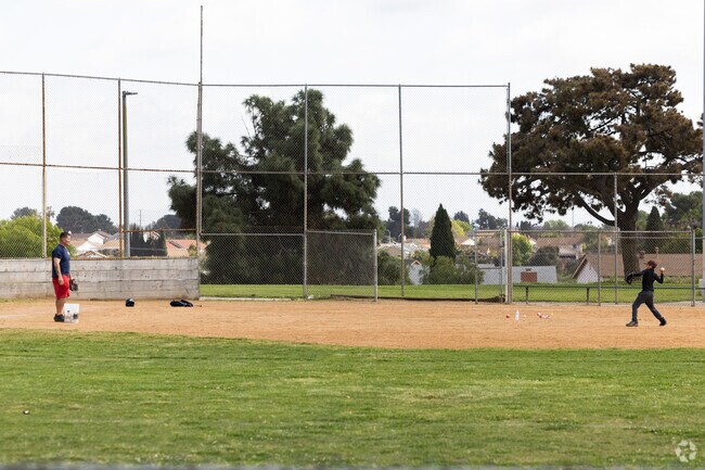 This dad is showing his kid how to play baseball in Skyline.