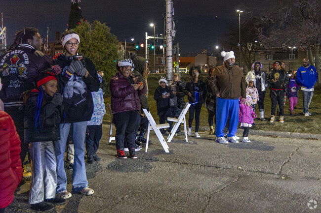 Downtown Maywood residents watch as Santa lines up to approach the stage.