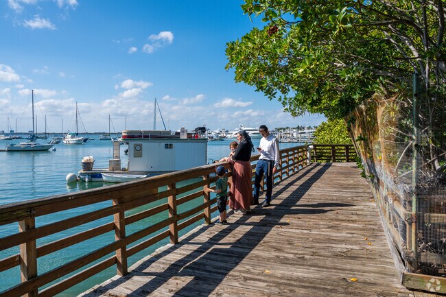 Family enjoying the sea breeze on the boardwalk at Maurice Gibb Memorial Park.