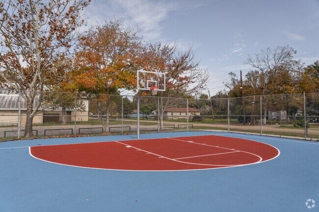 Basketball enthusiasts shoot hoops at Mills Avenue Park’s paved court in Highland Farms.