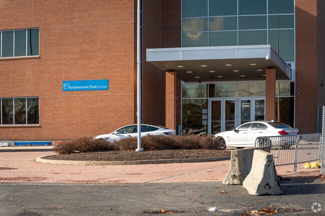 A couple of cars parked in front of Achievement First Academy located in Providence.
