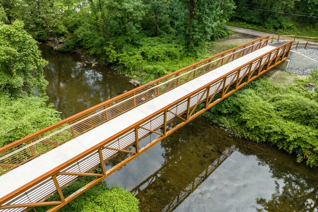 A steel footbridge crosses Darby Creek in Gillespie Park.