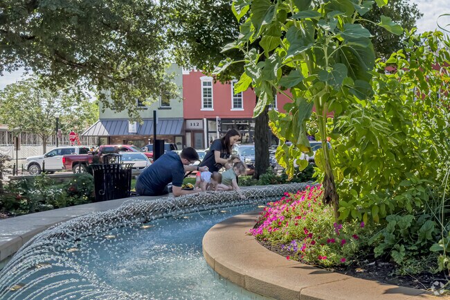 Families enjoy the fountain at nearby Bentonville Square.