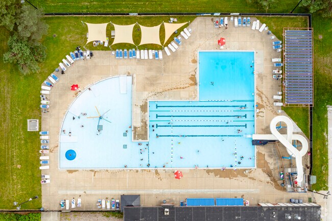 Veterans Memorial Park Pool features a dedicated splash zone and figure eight waterslide.