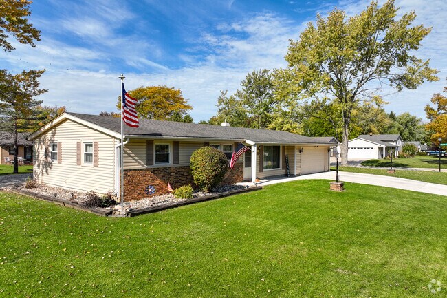 Brick ranch style home with large front yard and a tree in Centerhurst neighborhood.