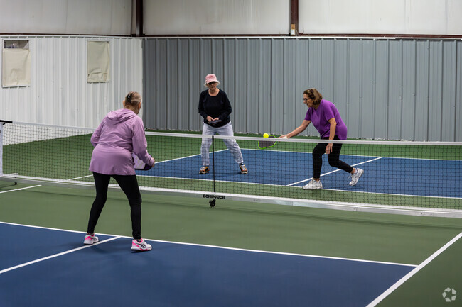 Friends learning how to play at Pickleball Citi located in Knightsville, Cranston.