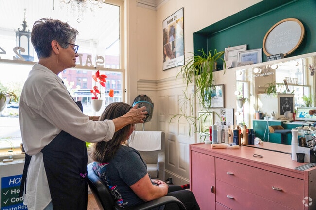 Sharon, owner of Salon 47 in the East Side, prepares to cut a client's hair.