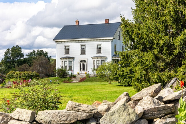 A colonial style home with a beautifully landscaped backyard in the Berlin neighborhood.