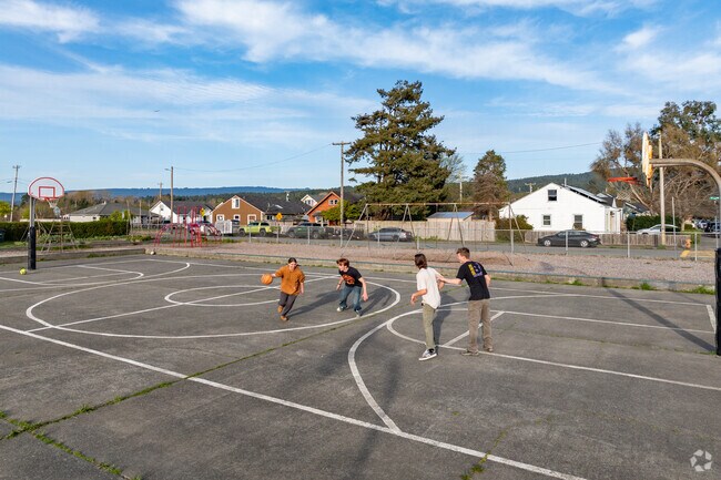 Children play a game of basketball at Coastal Grove Charter School.