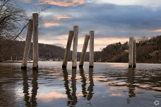 Sunset at Lake Zoar in Sandy Hook paints the sky with stunning colors over the calm water.