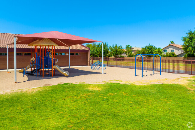 Unleash the joy of outdoor play on Pima Butte Elementary's grassy playground in Maricopa.
