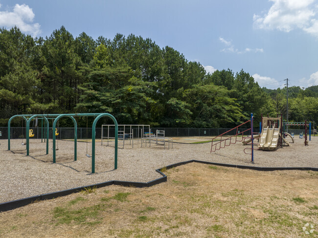 The playground at Pelham Oaks Elementary School has slides, swings, and monkey bars.