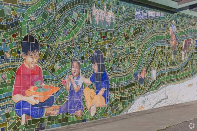A beautiful mosaic mural adorns the wall of the building in Jewel's Terrace Park in Albany Terrace.