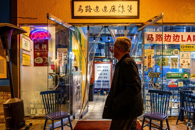 A shopper gazes into Ma Lu Bian Bian a hot pot restaurant at the food court in Rowland Heights