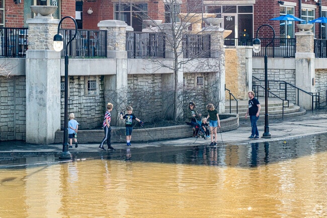 Children playing and exploring at the Naperville Riverwalk.