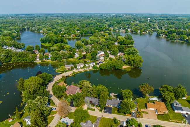 West Island Lake homes are intertwined among trees, beaches, and the lake.