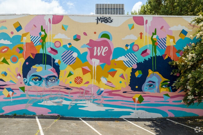 The vibrant mural, 'Together We,' depicts two black youths rising from the water in Vine City.