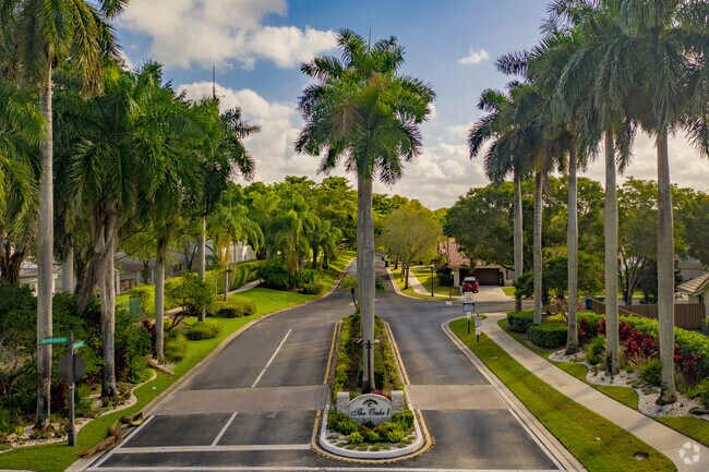 Palm trees line the street at the entrance of Country Isle.
