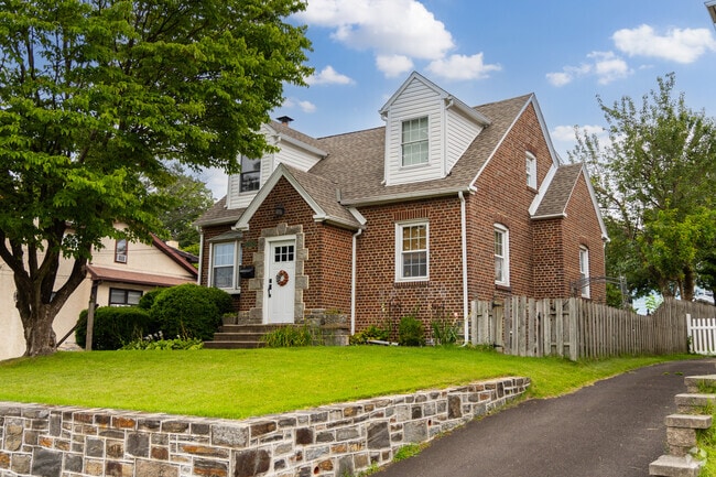 Trees and wood fences frame brick Craftsman homes throughout Rockledge.