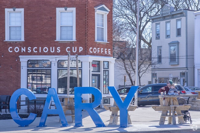 A Cary sign stands in the center of town in front of Conscious Cup Coffee.