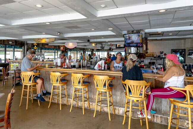 Grab a seat at the bar and enjoy great food & drinks at Our Deck Down Under in Ponce Inlet.