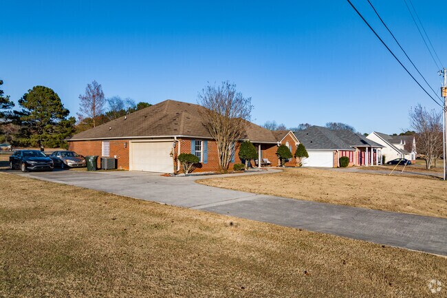 A beautiful row of brick homes with attached garages in Ready Crossing.