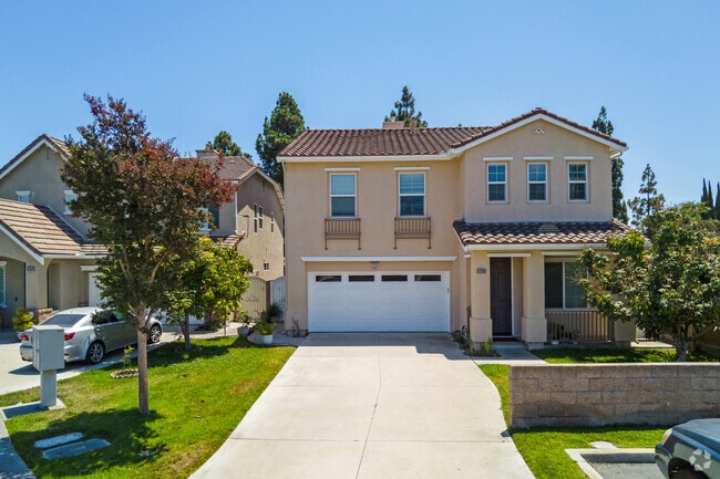 Modern Midway City homes feature Spanish tile roofs and stucco exteriors.