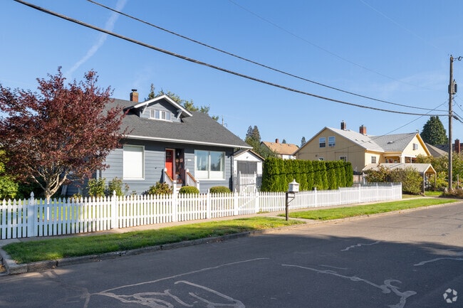 A charming home on B Street in Downtown Washougal is framed by a classic white picket fence, adding timeless curb appeal.