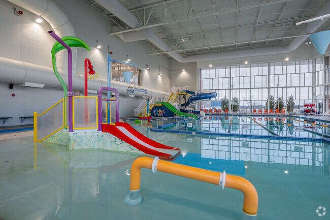 The community pool in Peak Health Aquatic Center at Mylan Park has splash and play features for all ages.