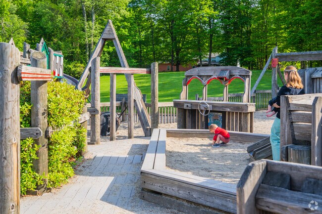 Shirley families play in the sandbox inside the Mystic Maze at Benjamin Hill Park.