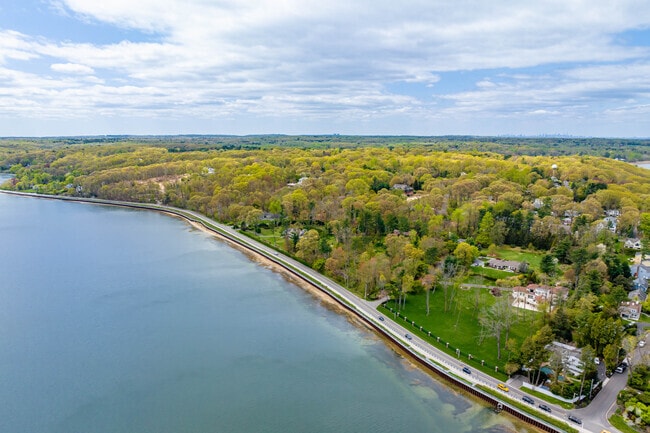 Estates along West Shore Road in Mill Neck overlook Oyster Bay, often Colonial Revival or Tudor.