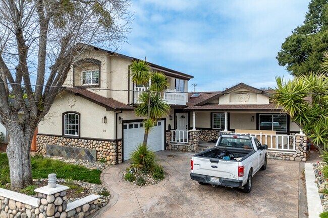 This unique Sunset West home features charming stone accents, a wraparound porch, and a spacious lot.