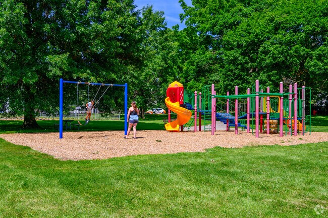 A mother an child play on the playground located in Clifford Park.