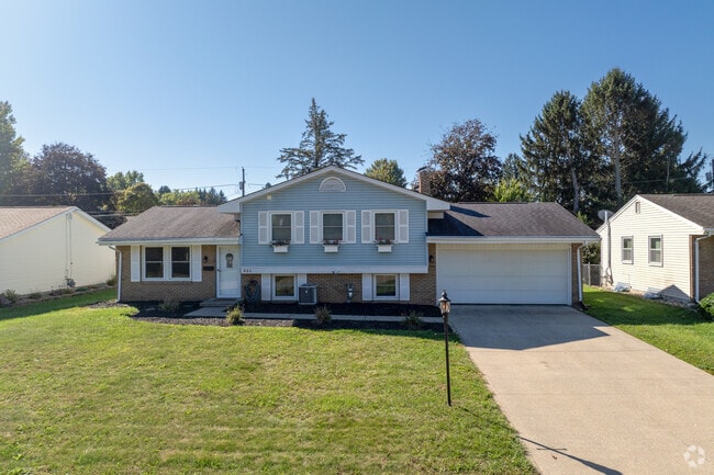 This split-level house in Lexington includes a spacious front yard and wooded backyard.