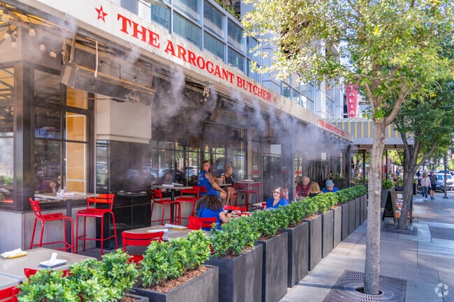 The Arrogant Butcher is a lively urban bistro with sidewalk dining, upscale American comfort food, and a popular happy hour scene near the Footprint Center and Symphony Hall.