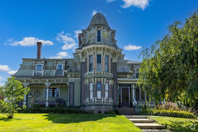 A truly eclectic home sits stately on it's spacious plot in Centralville.