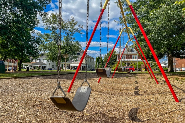 Push the children on the swings at Mount Wolf Park.