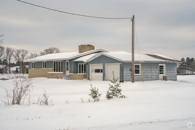 Ranch-style home in Zimmerman, Minnesota, surrounded by snow and open space in a quiet rural setting.