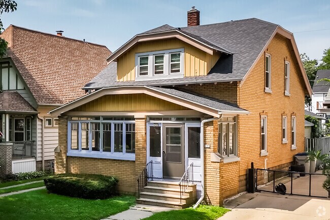 Cheerful Craftsman bungalows with cream brick facades populate Clarke Square.
